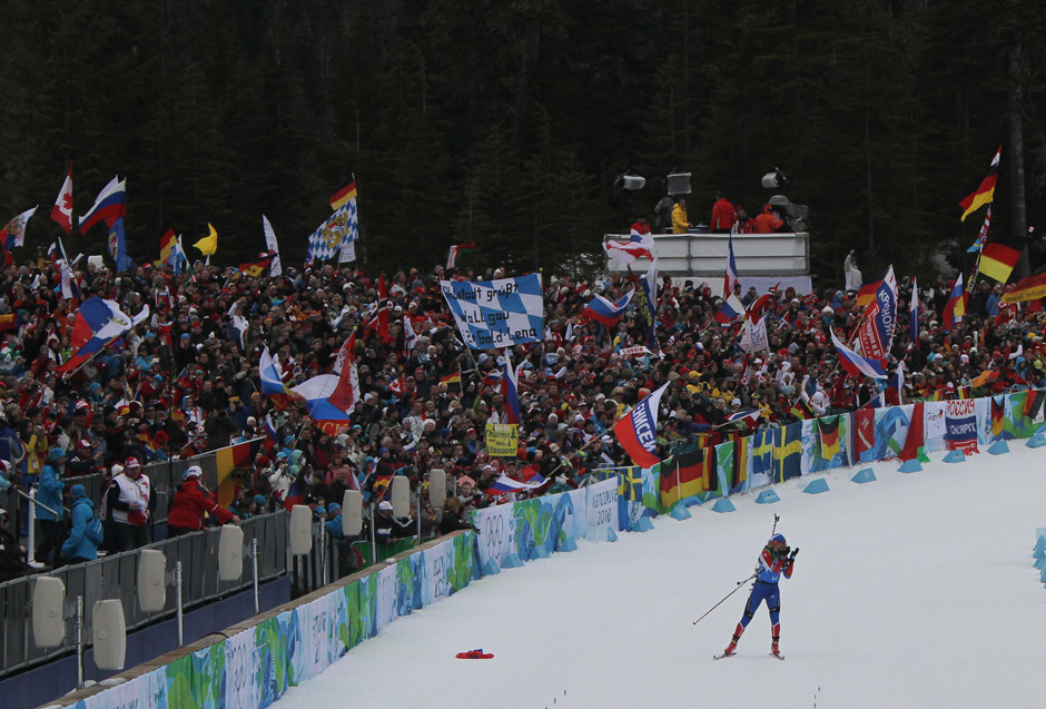 Olga Zaitseva blows kisses to the crowd as she brings Russia the gold in the Olympic biathlon relay in 2010.