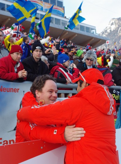 Max Cobb, who besides acting as CEO of USBA also chairs the International Biathlon Union's Technical Committee, receives a hug from a fellow official after U.S. athlete Susan Dunklee placed fifth in the 2012 World Championships.