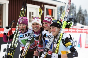 The U.S. women after placing third in a World Cup relay, the first relay podium in the history of the program – Kikkan Randall, Holly Brooks, Jessie Diggins, and Liz Stephen. Photo: NordicFocus/Felgenhauer/Fischer.