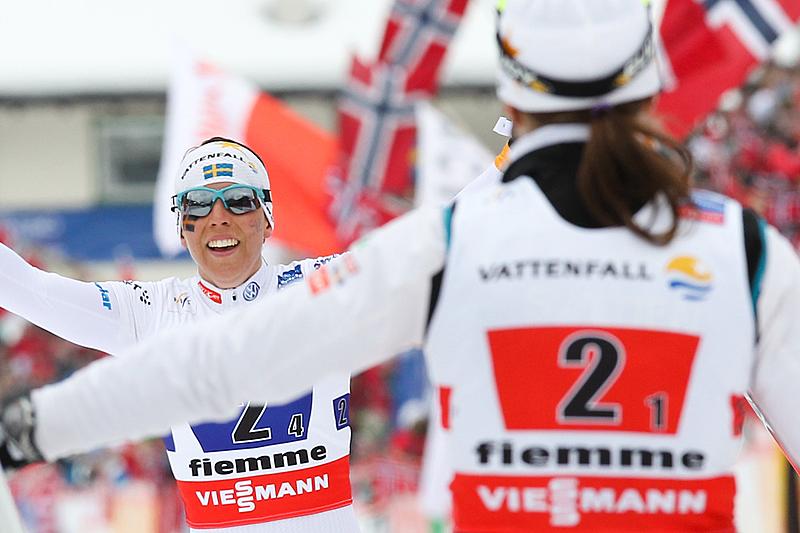 Sweden's scramble leg, Ida Ingemarsdotter (l) congratulates teammate Charlotte Kalla, who anchored their relay to silver on Thursday at the 2013 World Championships in Val di Fiemme, Italy. (Photo: Fiemme2013)