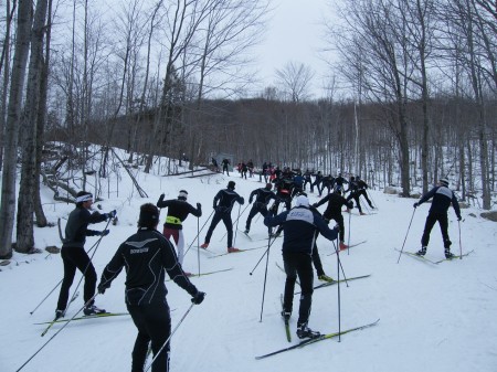 The men's field takes a more low-key ski up "High School Hill" after their race