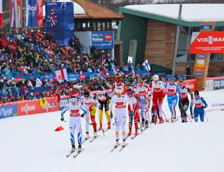 Sadie Bjornsen (bib 9) skis in the pack during the first leg's second lap through the stadium.