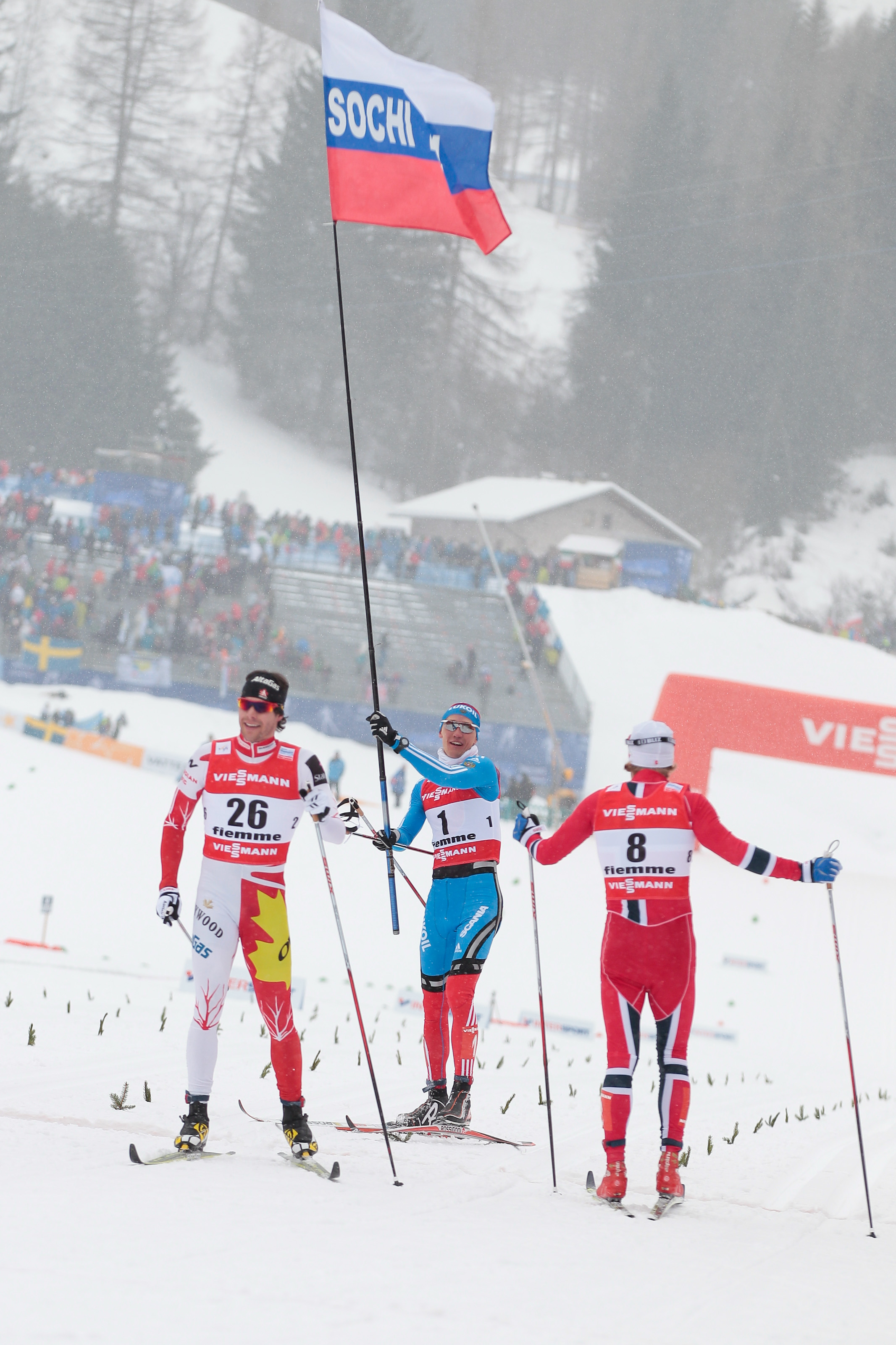 Alex Harvey (l) during a victory lap with Russia's Nikita Kriukov (c), who won the World Championships 1.5 k classic sprint on Thursday, and Norway's Petter Northug, who was second. (Photo: Fiemme2013)