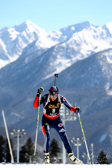 With the dramatic backdrop of Sochi's steep peaks, Susan Dunklee races to seventh place in today's 15 k individual race. Photo: USBA/NordicFocus.