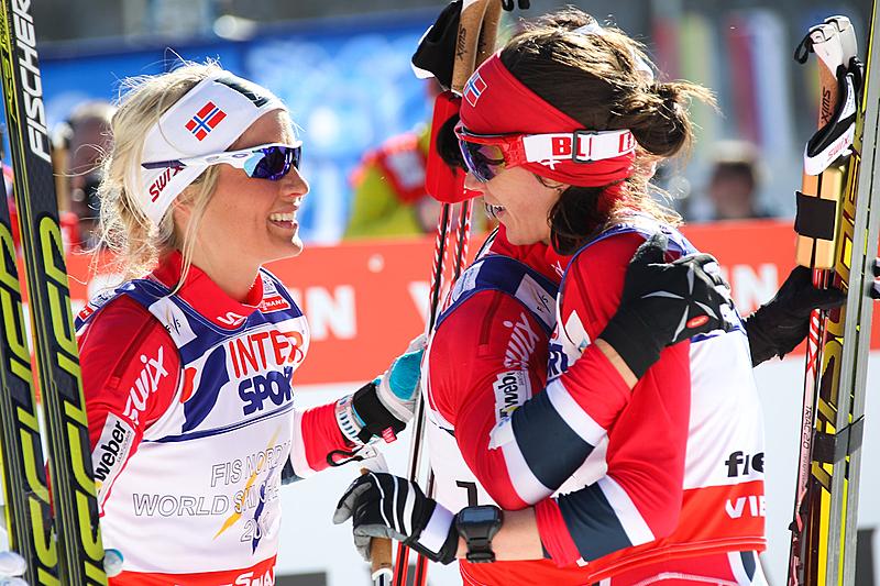 Norway's bronze medalist in Saturday's 30 k classic mass start, Therese Johaug (l) and fourth-place finisher Heidi Weng congratulate teammate Marit Bjørgen on her fourth victory at the 2013 World Championships in Val di Fiemme, Italy. (Photo: Fiemme2013)