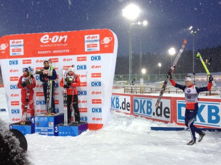 The podium ceremony: Fourcade on top, Landertinger, Svendsen, and Burke. Photo: Max Cobb.