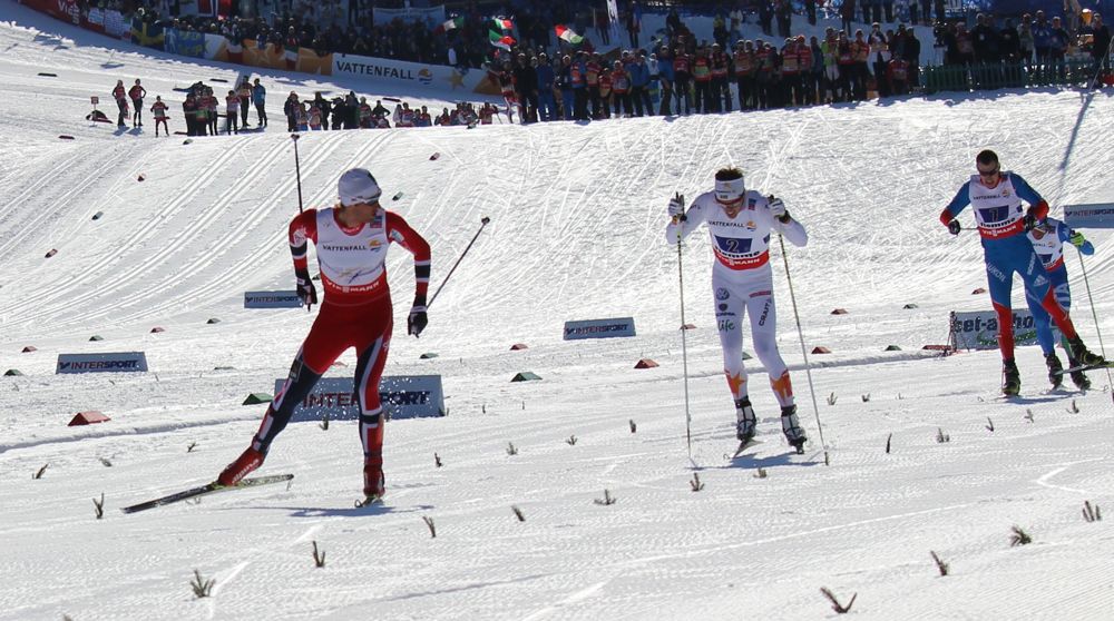 Petter Northug (l) checks back before celebrating Norway's victory in the 4x10 k relay at 2013 World Championships on Friday in Val di Fiemme. Calle Halfvarsson (second from l) anchored Sweden to silver, Russia's Sergey Ustiugov (second from r) was third, 0.2 seconds ahead of Italy's David Hofer.