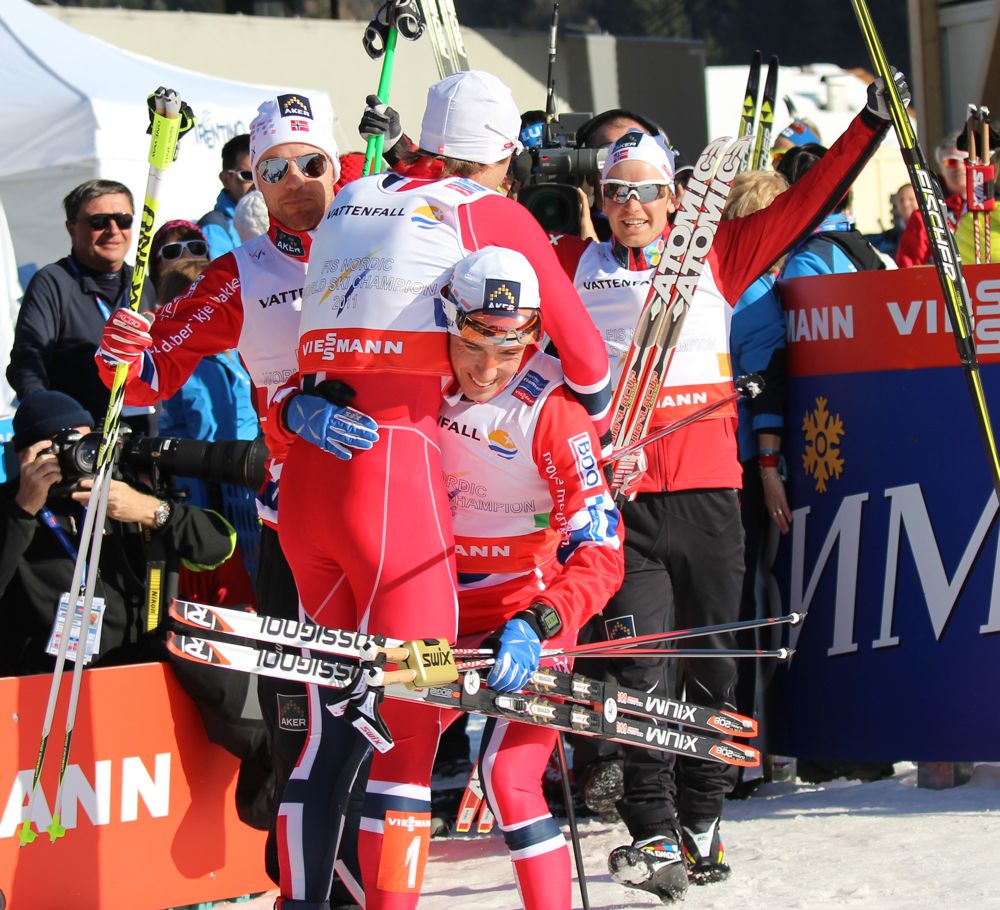 Eldar Rønning hoists teammate Petter Northug after the Norwegian anchor sealed the team's seventh straight World Championships relay victory on Friday in Val di Fiemme, Italy. Tord Asle Gjerdalen (l) and Sjur Røthe (r) join the party.