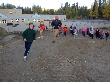 Dave Merrill, teacher at the Watershed School in Fairbanks, Alaska, runs with his class on the school's new Nordic terrain park. 