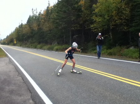 Liz Stephen receives encouragement from U.S. Ski Team women's coach Matt Whitcomb while leading the Climb to the Castle rollerski race on Sunday. 