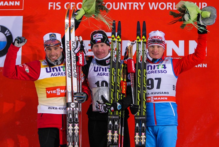 The men's podium in Kuusamo, Finland (FIN): (l-r) Eldar Roenning (NOR),  Lukas Bauer (CZE) and Dmitriy Japarov (RUS).  Photo: Fischer / Nordic Focus.