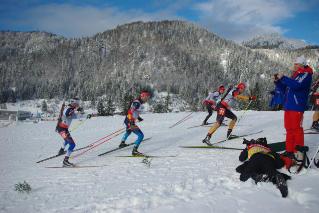 Lowell Bailey (left) and Jean Philippe Le Guellec (far side of pack) climb a hill early in the race, as U.S. head coach Per Nilsson takes video.