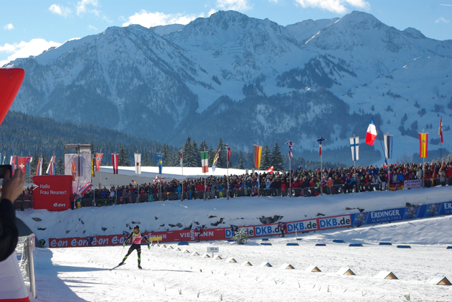 Martin Fourcade pumps up the crowd as he coasts towards the finish line in another victory.