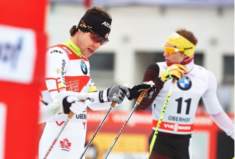 Canada's Alex Harvey (l) in the Tour de Ski leader's bib at the start of the 1.5 k skate sprint quarterfinals on Sunday in Oberhof, Germany. After winning the qualifier (for the first time), Harvey placed second in the heat and went on to finish 11th overall. (Photo: Fischer/Nordic Focus)