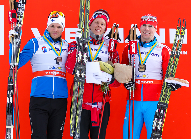 Martti Jylhae (left) on the World Cup podium with Anders Gloeersen, and Sergey Ustiugov in Davos, Switzerland, in 2013. (Photo: Fischer/Nordic Focus) 
