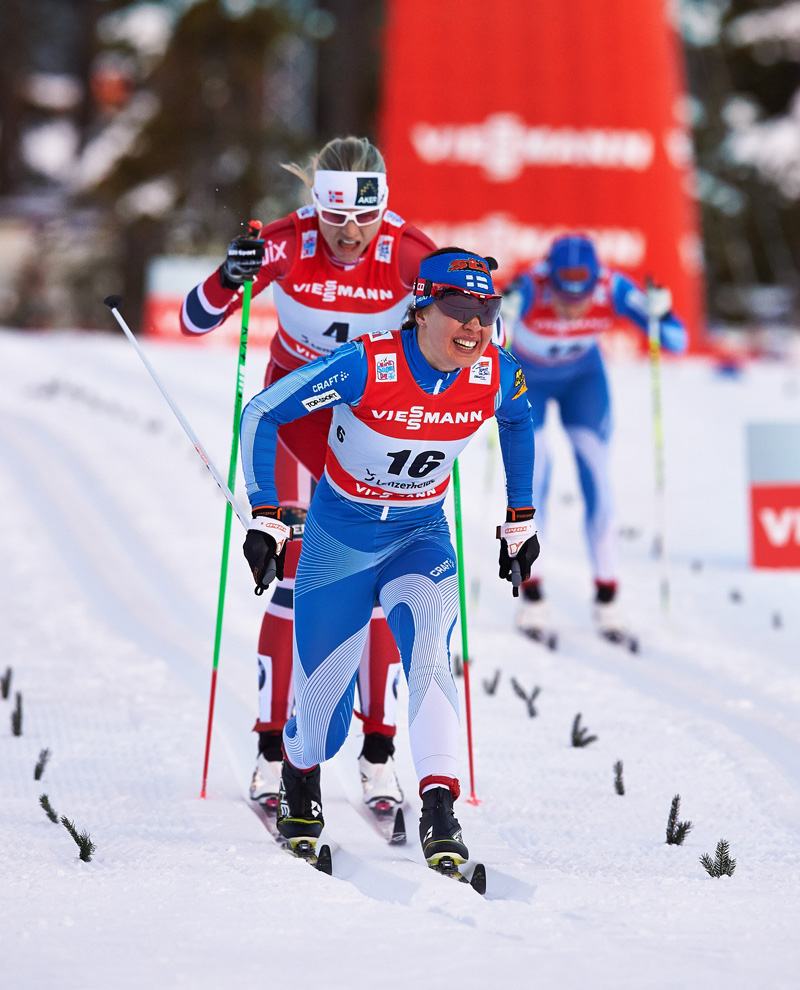 Finland's Kerttu Niskanen holds off Astrid Jacobsen of Norway to the finish of Wednesday's 10 k classic mass start to win Stage 4 of the Tour de Ski in Lenzerheide, Switzerland. (Photo: Fischer/Nordic Focus)