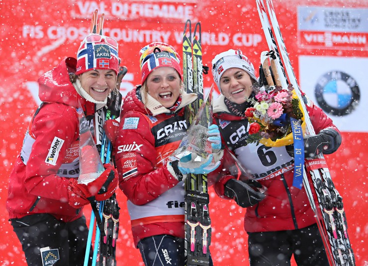 Astrid Jacobsen, Therese Johaug and Heidi Weng (l-r) on the podium at the conclusion of the 2014 Tour de Ski. Photo: Fiemme Ski World Cup