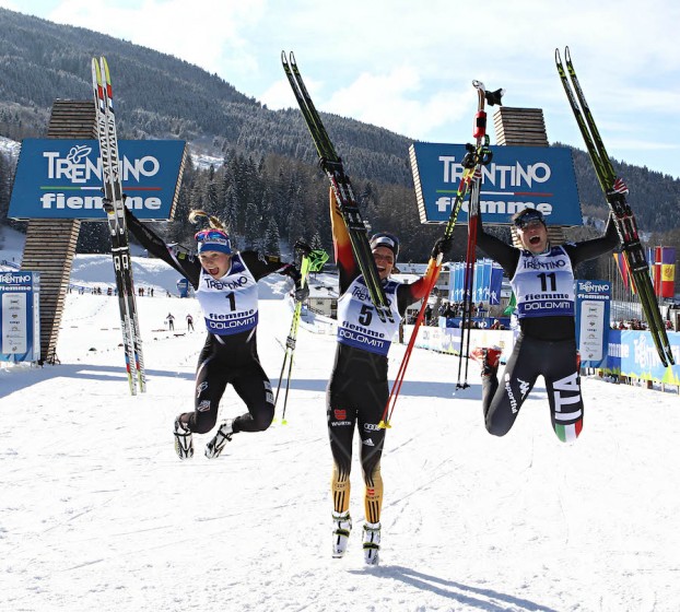 The U23 women's freestyle sprint top three jumping for joy at the finish (from left to right): runner-up Jessie Diggins (USA), winner Elisabeth Schicho (GER) and Giulia Stuerz (ITA) in third. (Photo: Fiemme2014)