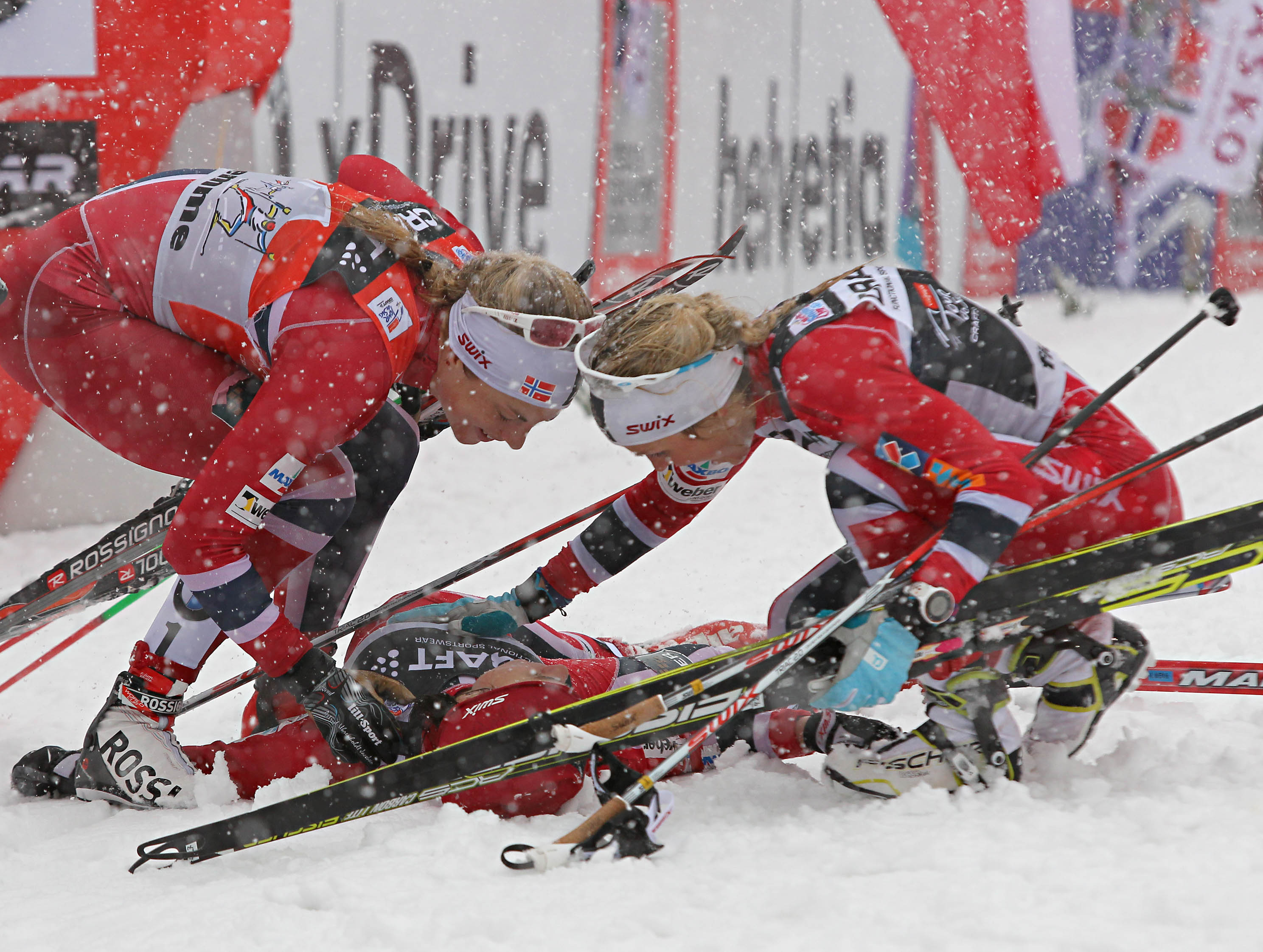 Jacobsen and Johaug greet Weng at the finish. Photo: Fiemme Ski World Cup