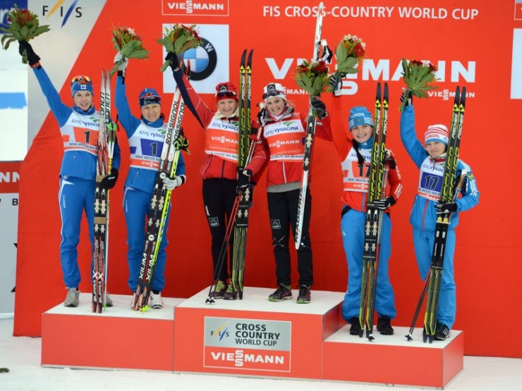 Nove Mesto World Cup classic team sprint podium, with Norway's Maiken Caspersen Falla and Ingvild Flugstad Østberg (c) on top, Finland's Mona-Lisa Malvalehto and Aino-Kaisa Saarinen (l) in second, and Russia's Evgenia Shapolova and Julia Ivanova in third. (Photo: Fischer/Nordic Focus)
