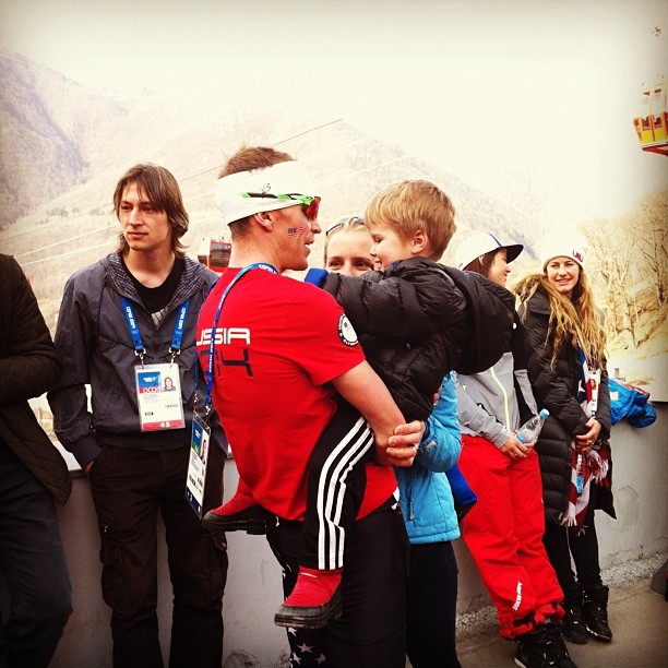 Billy Demong (l) with his son Liam and wife Katie after the final competition of the 2014 Sochi Olympics, the 4 x 5 k team event.