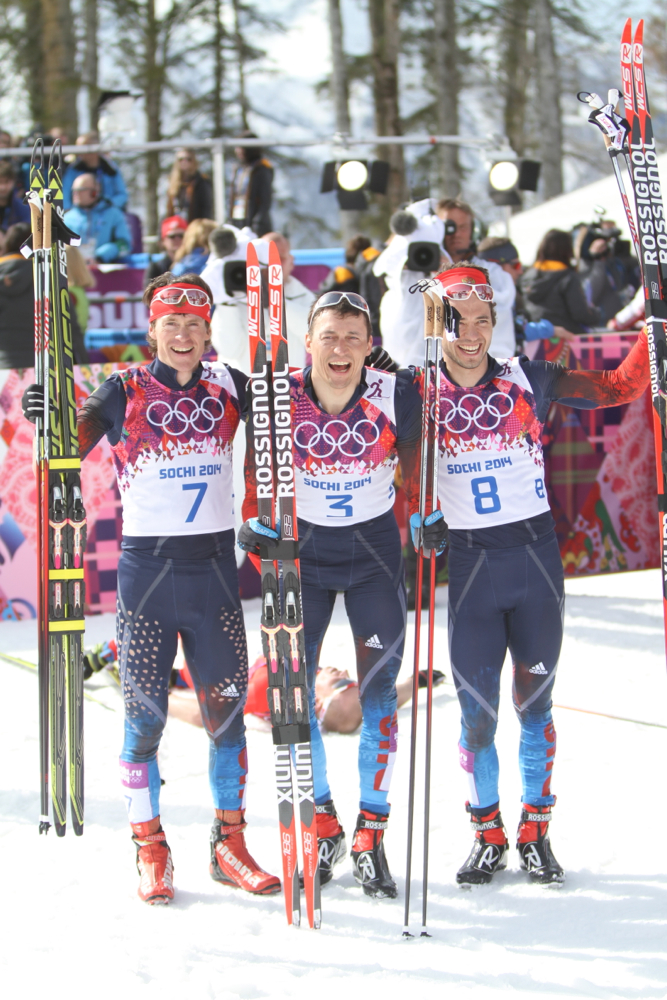 Alexander Legkov (center) and Maxim Vylegzhanin (left) are among the skiers served provisional suspensions for doping violations at the 2014 Olympics. Along with Ilia Chernousov (right, not suspended), they swept the 50 k mass start in Sochi.