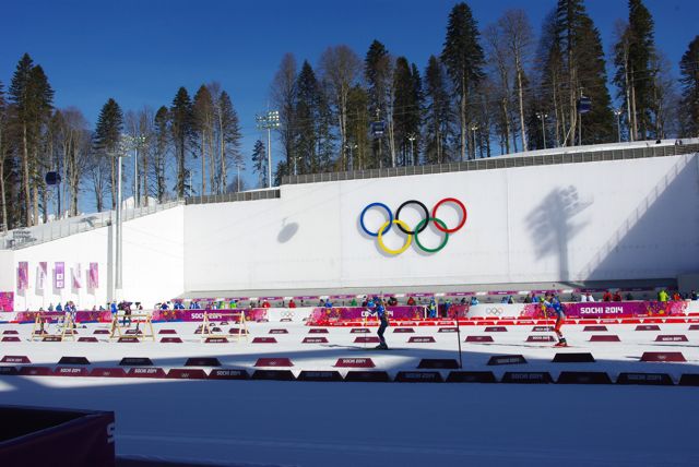 Biathletes ski through the Sochi stadium on the final training day before racing begins. 