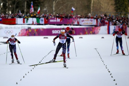 Sophie Caldwell (bib 9) heading for the finish in her Olympic quarterfinal heat in February, where she placed second to advance automatically to the semifinals.