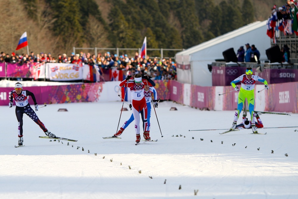 Østberg leads while Caldwell challenges her to the line in the women's 1.3 k freestyle sprint semifinal, which Østberg won by 0.01 seconds. Marit Bjørgen crashed in the finishing straight to place sixth.