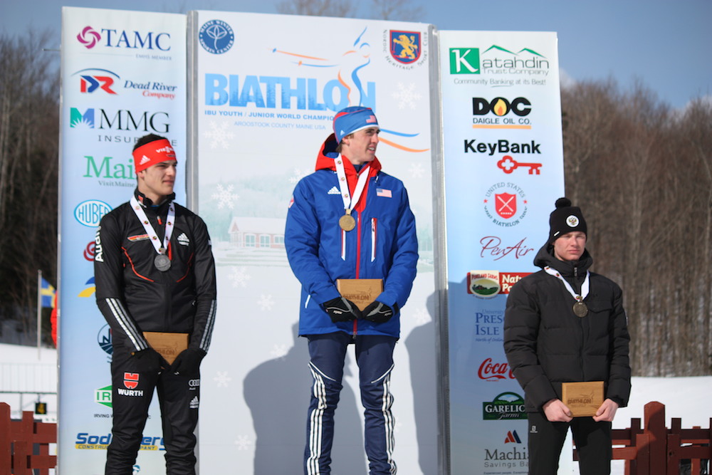 U.S. Olympian Sean Doherty (c) tops the podium in the first race of the 2014 IBU Youth World Championships in Presque Isle, Maine. Doherty won Friday's 7.5 k sprint ahead of Germany's Marco Gross (l) in second, and Russia's Dmitri Shamaev in third. (Photo: Craig Cormier)
