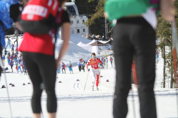 Canadian biathletes and fellow cross-country skiers cheer on their own Perianne Jones on the first leg of the 4 x 5 k relay at the Sochi Olympics on Friday. Jones dropped to 14th and the team finished 14th, one place better than their finish at the 2010 Vancouver Games.