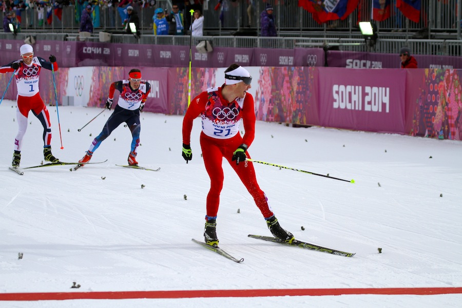 Switzerland’s Dario Cologna looks over at Sweden’s Marcus Hellner (not shown) before capturing his second Olympic gold in his first race of the 2014 Olympics — the 30 k skiathlon — on Sunday in Sochi, Russia. Hellner placed second while Norway’s Martin Johnsrud Sundby (l) and Russia’s Maxim Vylegzhanin (7) sprinted for third. Sundby won it but received a written warning for obstruction.