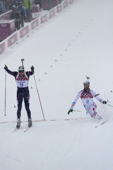 Norway's Emil Hegle Svendsen (l) celebrates a photo-finish victory over France's Martin Fourcade (r) in the men's 15 k mass start at the 2014 Sochi Olympics.