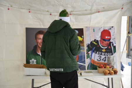 A skier pauses for a memorial to Torin Tucker, a Dartmouth College skier who died suddenly on February 1st during the Craftsbury Marathon.