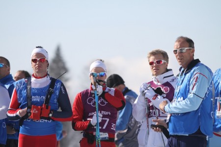 A group of dejected Norwegians watch the men's relay at the Olympics on Sunday.