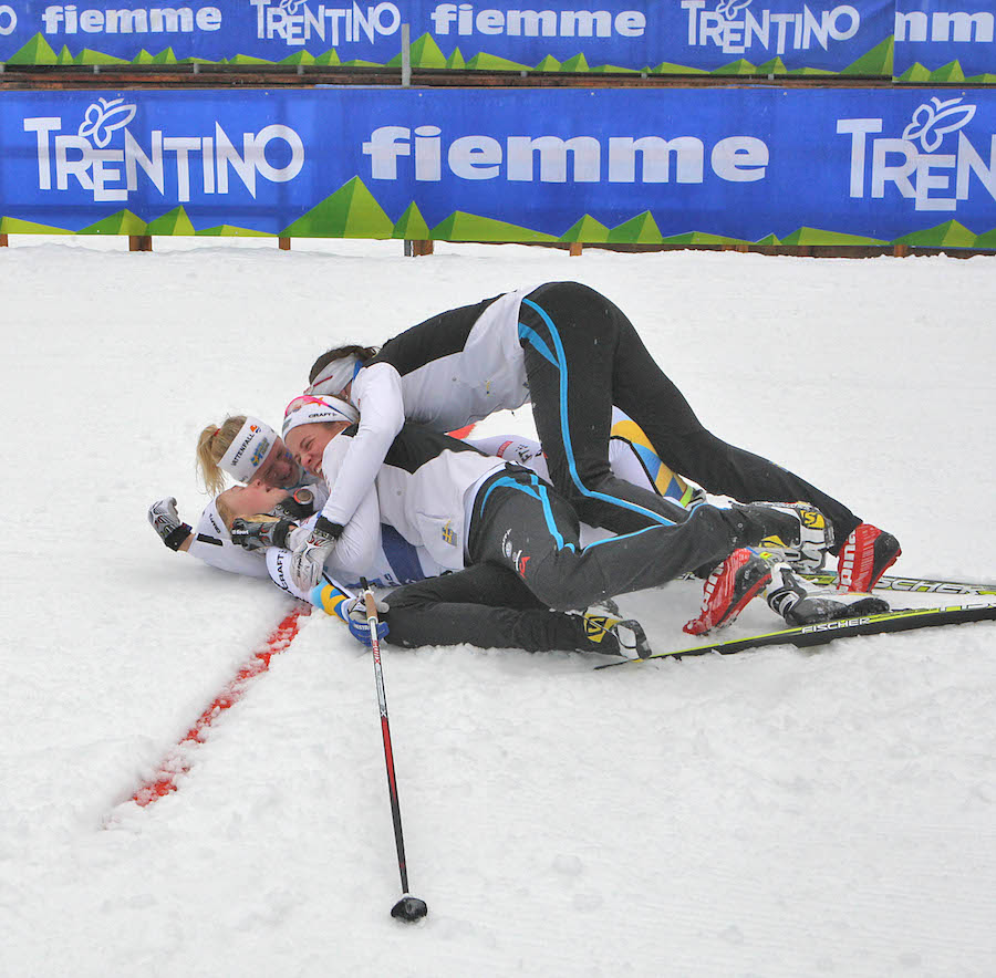 The Swedish women's relay team of Anna Dyvik, Sofia Henriksson, Maja Dahlqvist, and Jonna Sundling celebrate after defending their Junior World Championships relay title with another win on Monday in Val di Fiemme, Italy. (Photo: Fiemme2014)
