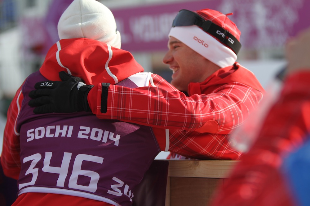 Dario Cologna hugs a member of his team, after the Swiss skier won Friday's 15 k classic individual start at the 2014 Winter Olympics in Sochi, Russia.
