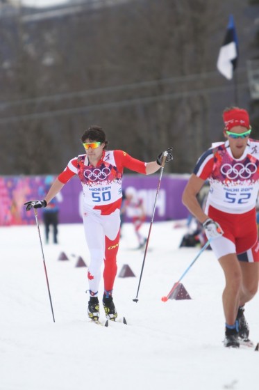 Canada's Alex Harvey stops for a moment to tell head coach Justin Wadsworth (not shown) that his skis aren't gliding. Harvey completed the second lap, but did not finish the 15 k classic individual start at the 2014 Olympics in Sochi, Russia.