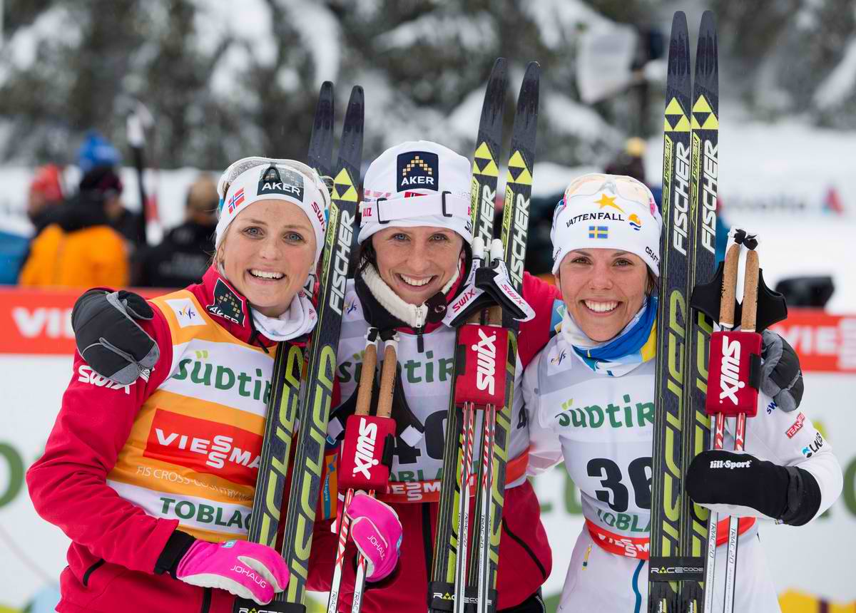 The women's 10 k classic individual start podium at the Toblach World Cup on Saturday, with Norwegian winner Marit Bjørgen (c), Norway's Therese Johaug (l) in second, and Sweden's Charlotte Kalla in third. (Photo: Fischer/NordicFocus)