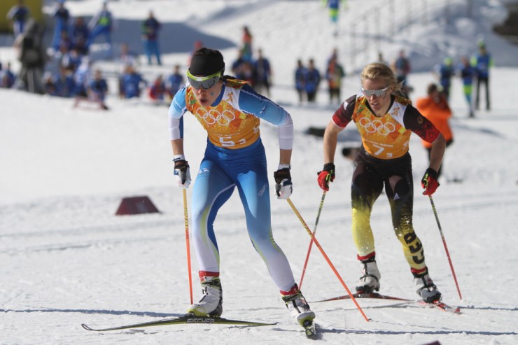 Kerttu Niskanen of Finland leading Claudia Nystad of Germany in the Olympic relay. Nystad completed her comeback from retirement with a bronze medal.