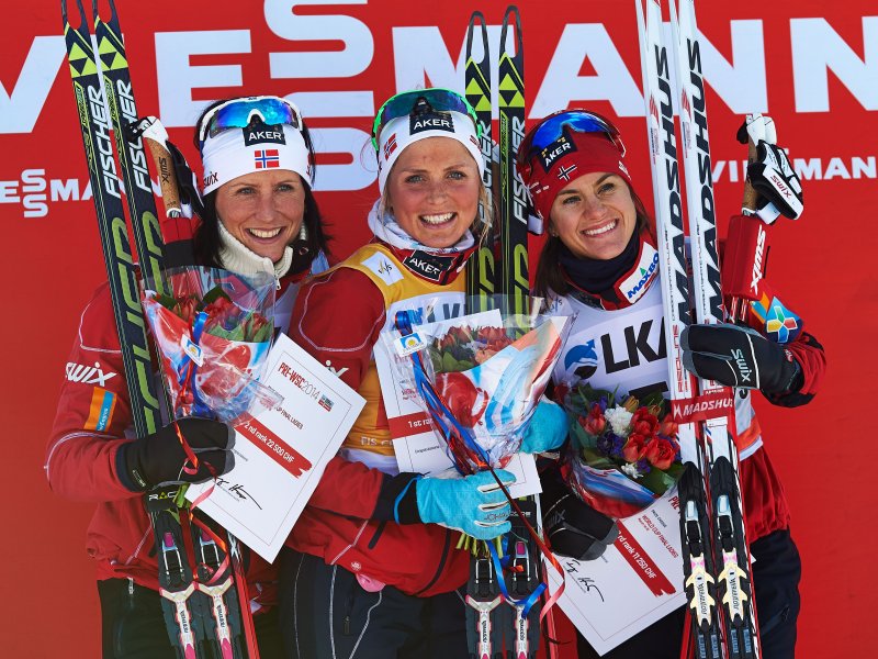 The women's 10 k freestyle pursuit podium on the last day of World Cup Finals and the 2013/2014 season, with three Norwegians: winner Therese Johaug (c), runner-up Marit Bjørgen (l), and Heidi Weng in third. (Photo: Fischer/Nordic Focus)