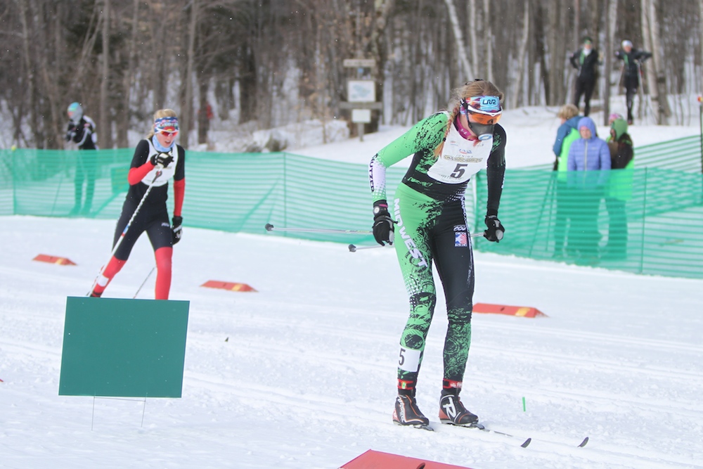 Amanda Kautzer (r) of Loppet Nordic Racing/Midwest, crests the final hill in Wednesday's 1.4 k classic sprint A-final before winning her first title at Junior Nationals, ahead of runner-up Hailey Swirbul (Aspen/Rocky Mountain), in Stowe, Vt.