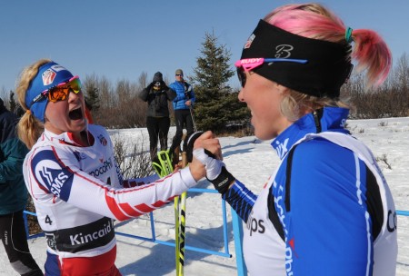 Jessie Diggins (l) congratulates her fellow U.S. Ski Team member Kikkan Randall on her win after racing Randall in Sunday's classic-sprint final at Kincaid Park in Anchorage, Alaska. Diggins placed fifth, 8.86 seconds back. (Photo: Bill Roth/Anchorage Daily News)
