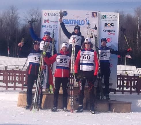 Flower ceremony for the 12.5 k youth individual competition: Sean Doherty (USA) in second, Alexandre Dupuis and Jules Burnotte (CAN) in fifth and sixth. Photo: Biathlon Canada.