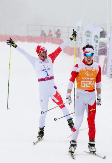 Canada's Brian McKeever (l) celebrates his ninth-career Paralympic gold, which he won Wednesday in the 1 k visually impaired sprint with guide Graham Nishikawa in Sochi, Russia. While Nishikawa helped him win his first gold of the week in the 20 k classic with guide Erik Carleton, this was Nishikawa's first Paralympic gold. (Photo: Matthew Murnaghan/Canadian Paralympic Committee)