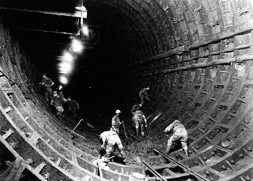 Workers build a wall in the Lincoln Tunnel during its construction from 1934-1937. (Photo: NARA) http://newdeal.feri.org/library/d64b.htm