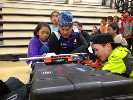 Zach Hall teaches shooting skills at an indoor range in Kotzebue. "Biathlon is a huge component of the program that makes cold days manageable since we stay inside shooting biathlon infrared systems," says Flora. 