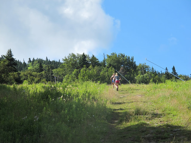 Erika Flowers and Sophie Caldwell work together during their ski walking intervals in Stratton in 2013.