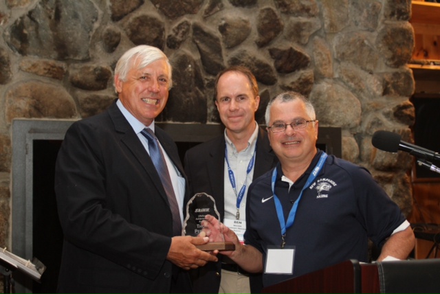 UNH Nordic Ski Team coach Cory Schwartz and Ben Wilcox present the Lifetime Achievement Award to Thom Perkins; Ski NH