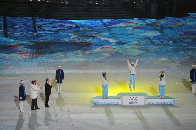 Kristin Størmer Steira on the podium at the Sochi Olympics closing ceremony with teammates Marit Bjørgen (top) and Therese Johaug, after Norway swept the podium in the women's 30 k freestyle mass start, the last cross-country race of the Olympics. (Photo: Wikimedia Commons)